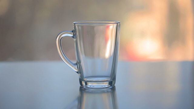 hot water over tea in transparent glass cup