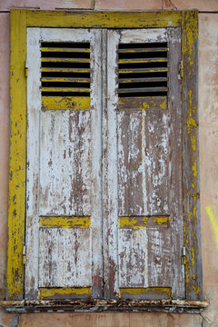 The window of old house with shutting shutters