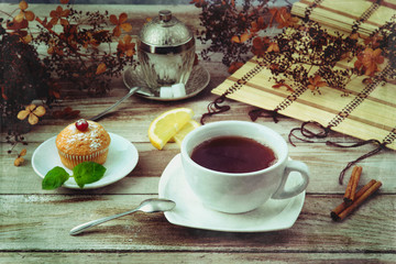 Cup of black tea with muffin