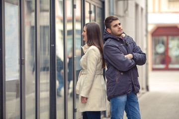 Young couple standing in front of the boutique