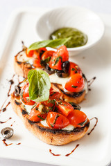 Bruschetta with tomato, mozarella and basil