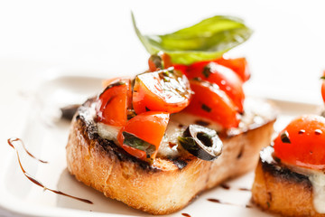 Bruschetta with tomato, mozarella and basil