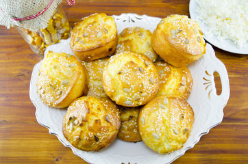 Plate full of corn bread muffins on a table