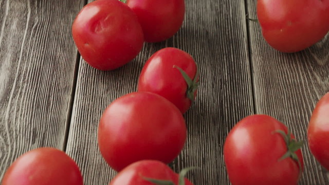 Tomatoes Roll Over The Screen In Slow Motion