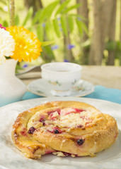Cake with berries on garden table
