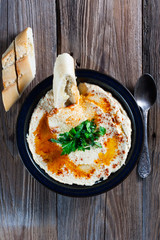Fresh hummus with parsley and oil.