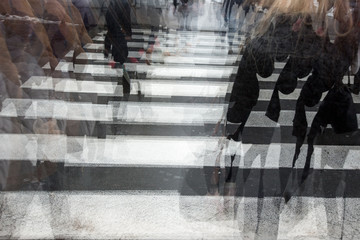 People crossing a road, blurred, in motion