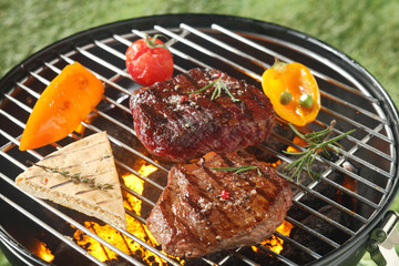 Succulent tender rump steak grilling on a barbecue