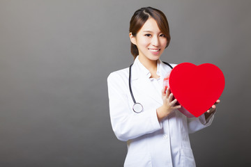 smiling asian female doctor with heart