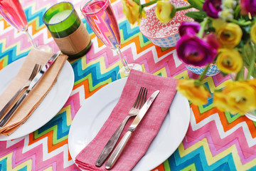 Bright colorful table setting with chevron tablecoth