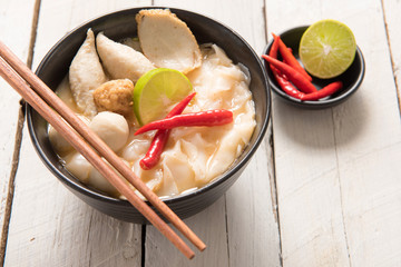 Bowl of spicy soup with noodles and vegetables for a delicious a