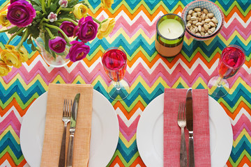 Overhead Bright colorful table setting with chevron tablecoth