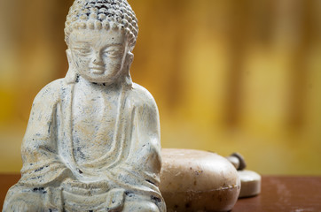 buddha sculpture with soaps and stones spa concept