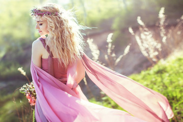 Beautiful blonde girl in pink long dress © Cliplab