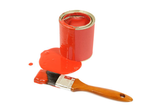 Messy red paint tin with spilled paint puddle and paintbrush photo