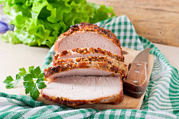 Cut pieces of baked meat on the table