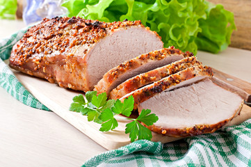 Cut pieces of baked meat on the table © timolina