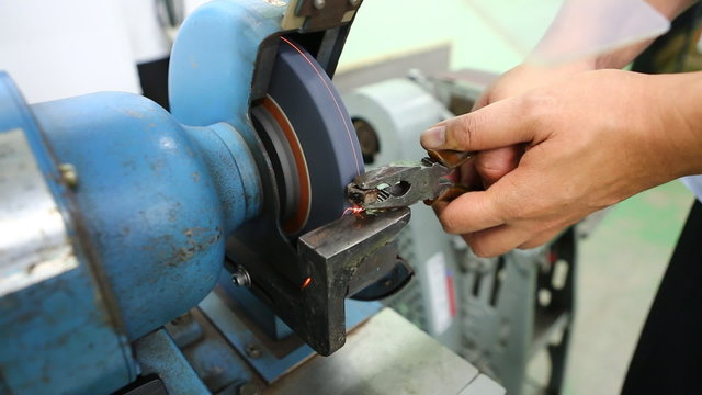 Technician uses grinder to modify nut