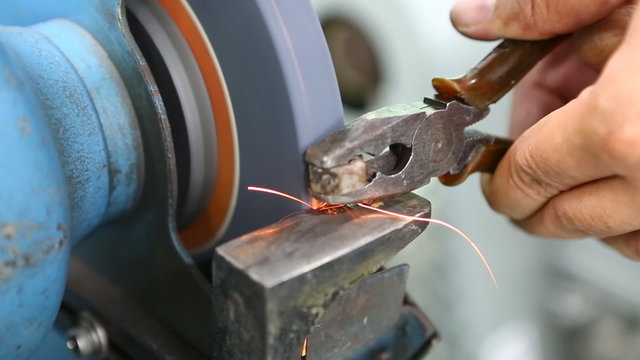 Technician uses grinder to modify nut