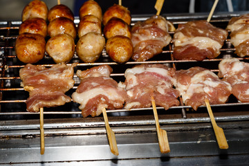 Fried meat balls a grill on a stick in sauce