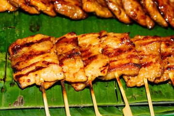 Fried meat balls a grill on a stick in sauce