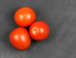 very fresh red tomatoes on a slate