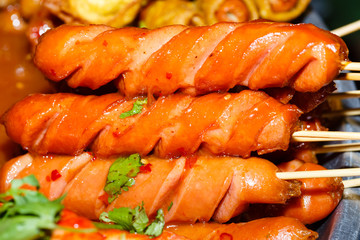 Fried meat balls a grill on a stick in sauce