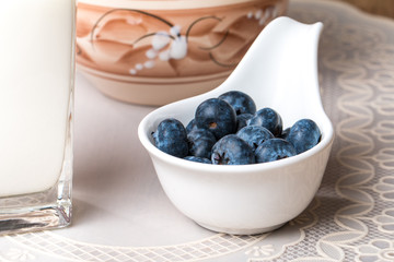 blueberries and milk products on wooden table