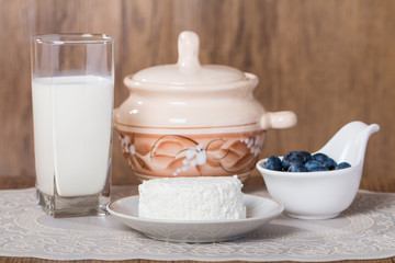 blueberries and milk products on wooden table