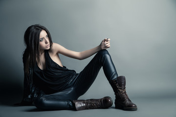 Fashion model wearing leather pants and jacket