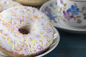 Donuts with icing and colored sprinkles confectionery.
