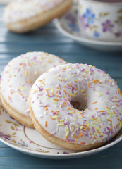 Donuts with icing and colored sprinkles confectionery.