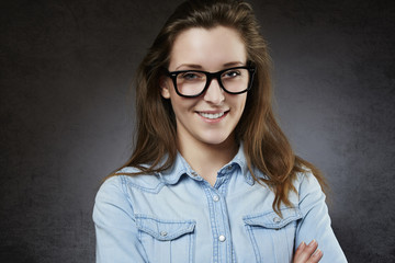 Fototapeta premium Smiling cute teenager in nerdy glasses