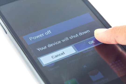 finger press power off button on smartphone
