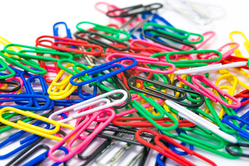 Colorful paperclips on white background isolated