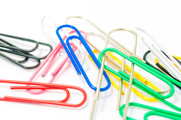 Colorful paperclips on white background isolated