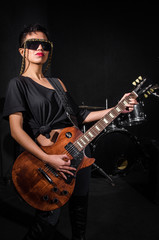 Obraz premium Young woman playing guitar during the concert