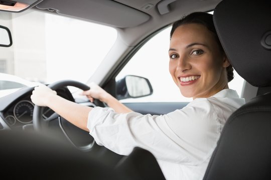 Woman smiling at camera while driving