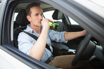 Man drinking beer while driving