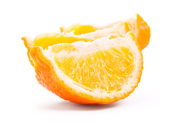 Slices of tangerine isolated on white background, close-up