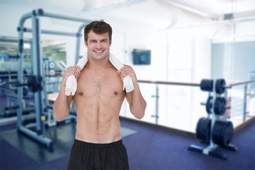 Fototapeta na wymiar Composite image of fit shirtless man smiling at camera