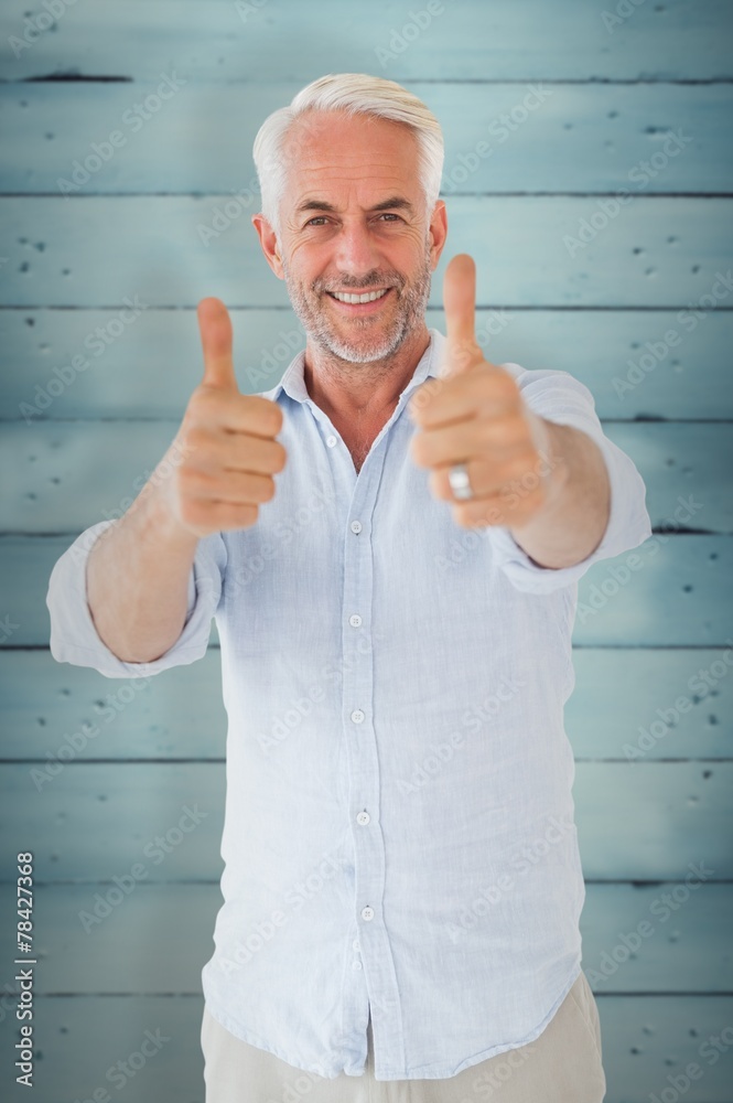 Poster Composite image of smiling man showing thumbs up to camera