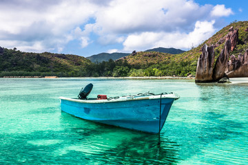 Naklejka na ściany i meble Old fishing boat on Tropical beach at Curieuse island Seychelles