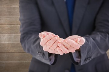 Obraz premium Composite image of handsome businessman presenting with hands