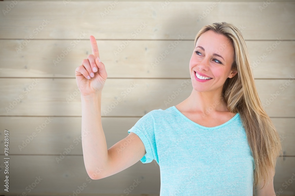 Poster Composite image of portrait of smiling blonde pointing up