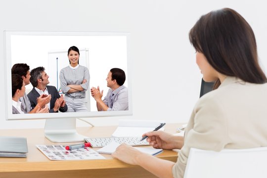 Composite image of portrait of a business team sitting together