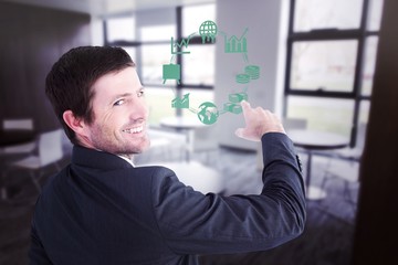 Composite image of businessman pointing with his finger