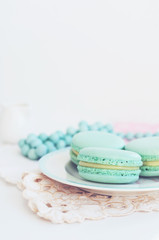 Backdrop with minty macaroon on light background