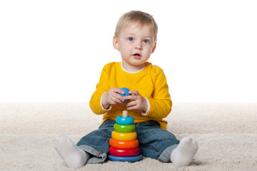 Clever infant boy with a toy