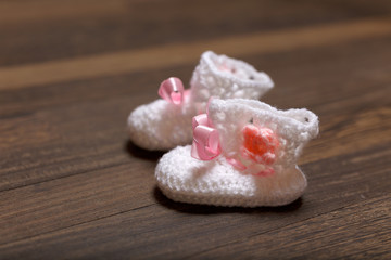 baby's bootee on wooden background